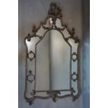 A 20th century metal wall mirror, the frame with scrolling foliate design, 125 x 74cm