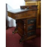 A Victorian mahogany davenport, with two short drawers over hinged lid, having an arrangement of