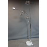 A Roche Bobois five branch chrome floor standing lamp, on marble base, with label to base, H.212cm