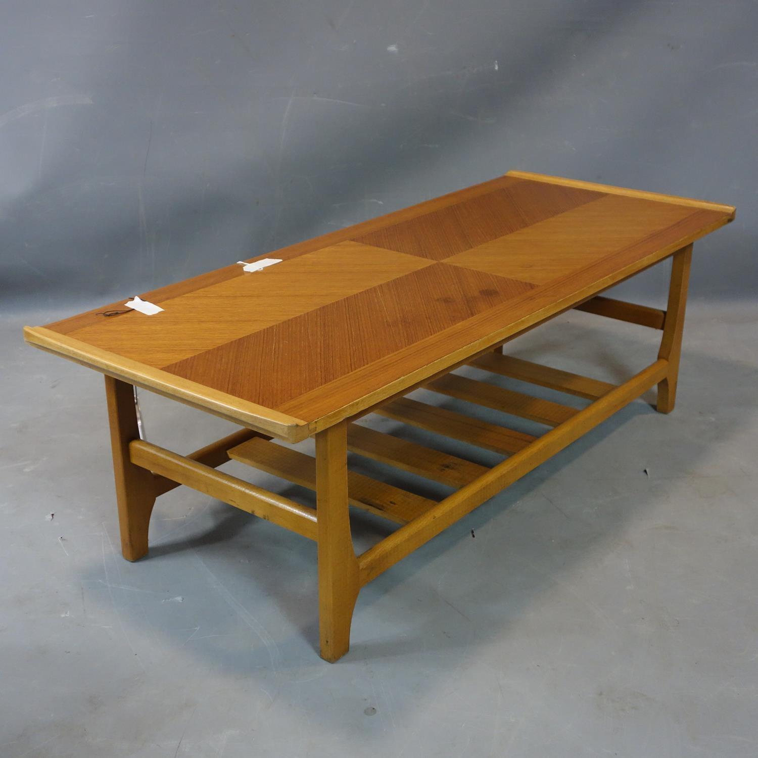 A teak coffee table, with undertier rack, H.35 W.111 D.46cm - Image 2 of 3