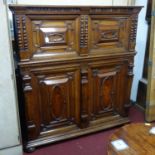 A 17th century oak panelled Antwerp cabinet, with four carved panelled doors, on moulded base and
