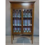 An Edwardian inlaid mahogany display cabinet, raised on tapered legs, H.164 W.92 D.36cm