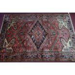 A Northwest Persian Heriz carpet, central diamond medallion with repeating geometric motifs on a