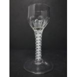 An early George III opaque-twist wine glass, c.1765, the ovoid bowl with panel moulding, the stem