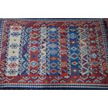 A South West Persian Qashqai Kilim, with repeating stylised geometrical motifs surrounded by