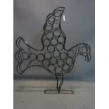 A vintage wrought iron wine rack in the form of a dove, H.110 W.96 D.15cm