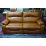 A contemporary electronic reclining tan leather sofa