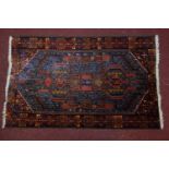 A Persian rug with geometric design, on a blue ground, contained by geometric border, 134 x 83cm