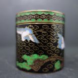 A small Chinese cloisonne enamel box, decorated in pink, blue and green with cranes amongst trees on