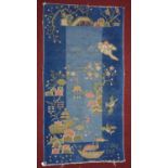 An early 20th century Chinese rug decorated with flowers, birds and boats, on a blue ground, 180 x