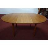 A 20th century teak dining table with fold in butterfly leaf, raised on tapered legs, H.73 W.176 D.