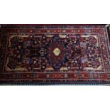 A North West Persian Nahawand Carpet, the cental diamond medallion with repeating petal motifs, on a