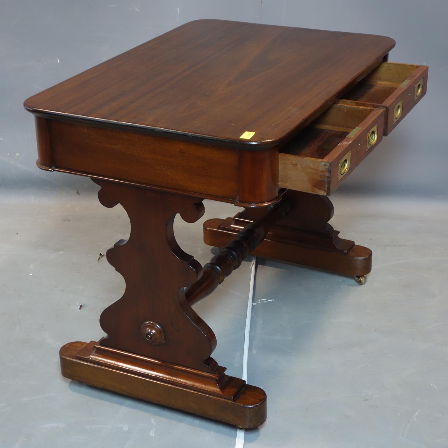 A 19th century mahogany campaign writing table with two drawers, on trestle supports and castors, - Image 2 of 2