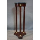 A Regency style mahogany circular marble top lamp table, with brass mounts, label for Bombay