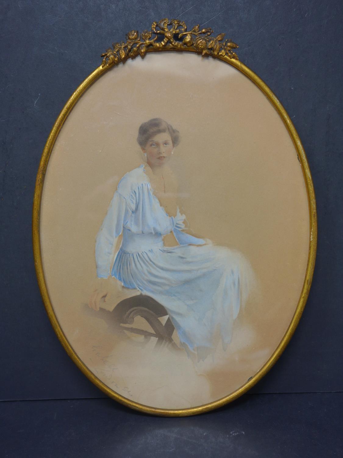 A late 19th century studio photograph of a young lady, hand-painted, within a decorative brass - Image 2 of 3