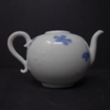 A Chinese blue and white miniature teapot, decorated with petals, bearing label for Peer Groves