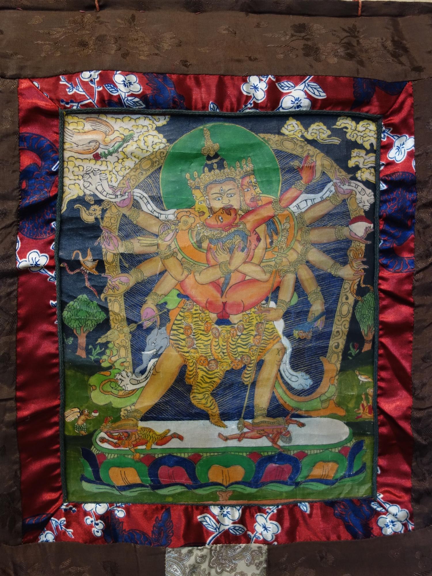 A hand-painted Tibetan Thangka depicting a deity in a landscape scene with animals, having script to - Image 6 of 7