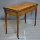 A Georgian inlaid mahogany card table, raised on tapered legs and castors, H.72 W.91 D.44cm