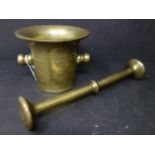 A mid 19th century Bedouins brass pestle and mortar, used to grind coffee, H.10.5 W.12.5cm (mortar),