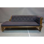 In the style of Charles Bevan, a Gothic Revival chaise longue, having scroll arms and raised on