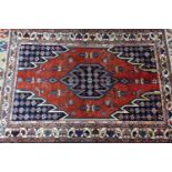 A North West Persian Mazlaghan Rug, the central diamond medallion with repeating petal motifs, on