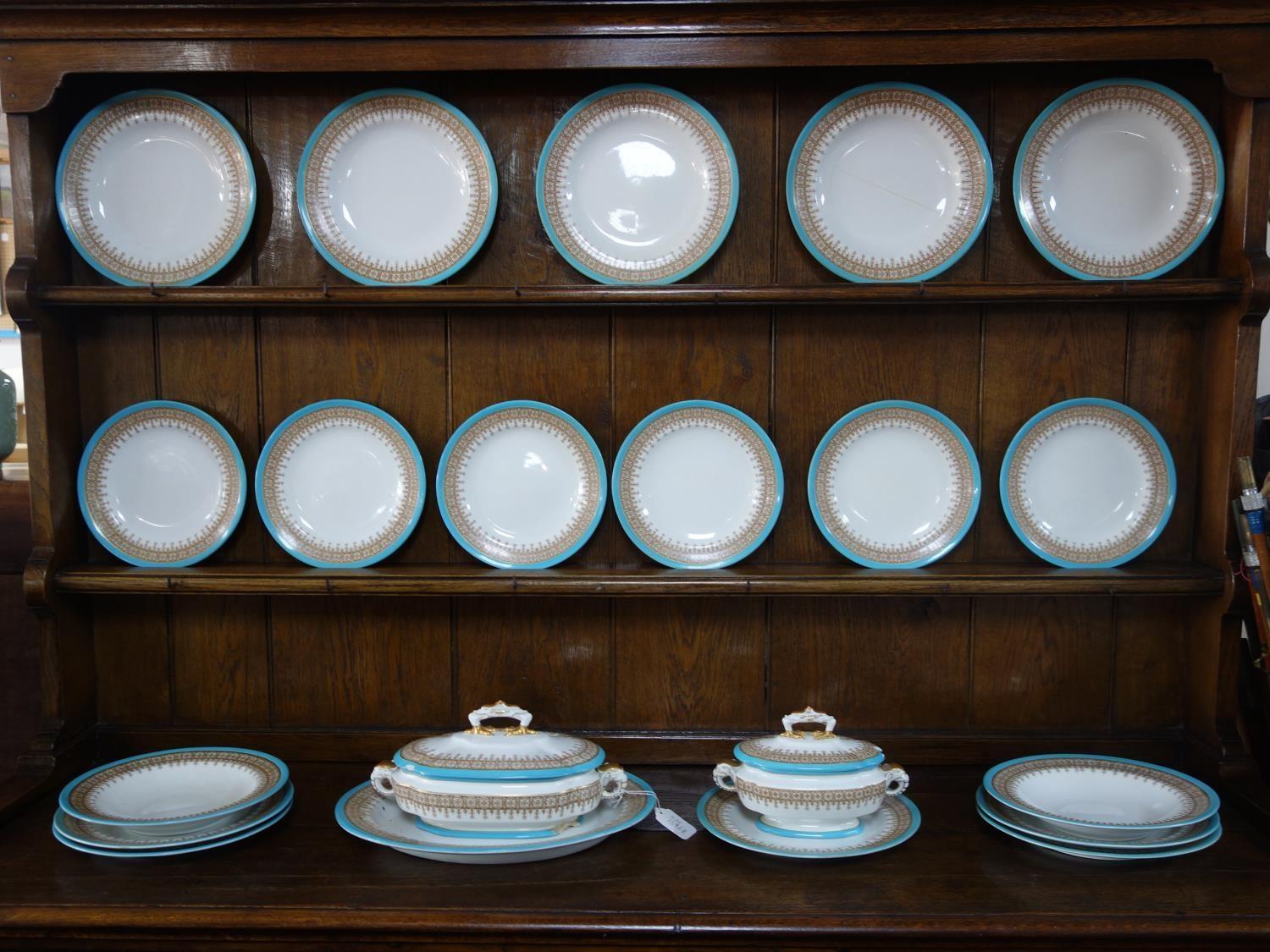 A Royal Worcester part dinner service, with turquoise rim and gilt floral border, marked to bases,