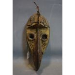 A West African tribal carved bird mask by the Grebo people, Sierra Leone, with quills, plaque and