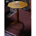 A Victorian walnut tripod wine table, with octagonal top on turned support and tripod feet, H.73 W.