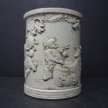 A Chinese blanc de chine brush pot, decorated in relief with children and bats, bearing seal mark to