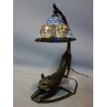 A Tiffany style lamp, the base in the form of a bronze out stretched cat, H.43cm