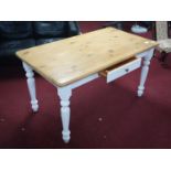 A pine kitchen table with single drawer, raised on painted base and turned supports, H.75 W.139 D.