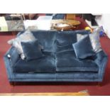 A Duresta 'Collingwood' sofa with blue velvet upholstery, raised on tapered legs