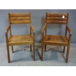 A Pair of 20th century oak armchairs, with carved backrests