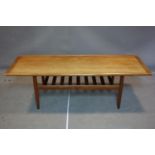 A Danish teak coffee table with undertier rack, on tapered legs, H.52 W.161 D.60cm