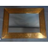 A large contemporary copper clad mirror, with bevelled plate, 122 x 91cm