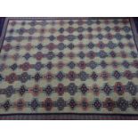 A Soumak carpet with repeating geometric motifs, on a beige ground, contained by geometric border,