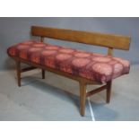 A mid 20th century teak hall bench, with back rest and upholstered padded seat, possibly by A.