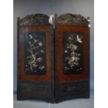 A large 19th century Japanese lacquered hardwood 2 fold dressing screen, with ivory decoration