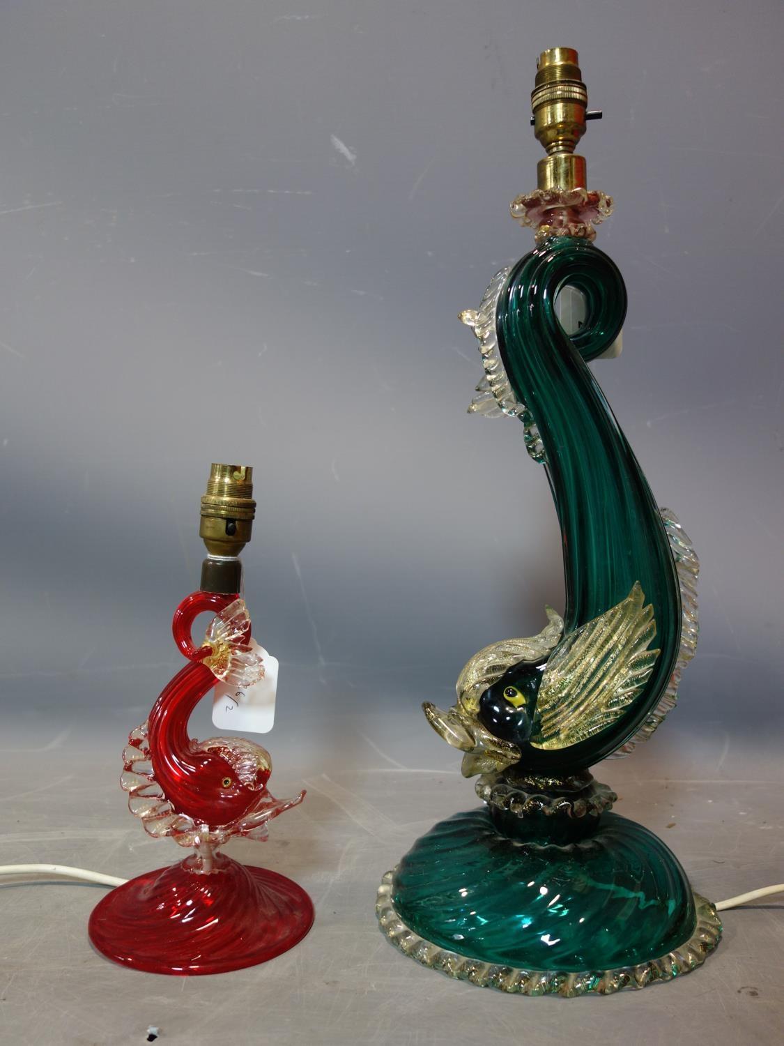 A 20th century Murano green glass dolphin lamp, together with a smaller red example