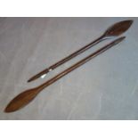 Two tribal carved hardwood oars, H.129cm and H.120cm
