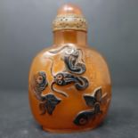 A Chinese resin snuff bottle and snuffer, relief decorated with fish and verse, H.7cm