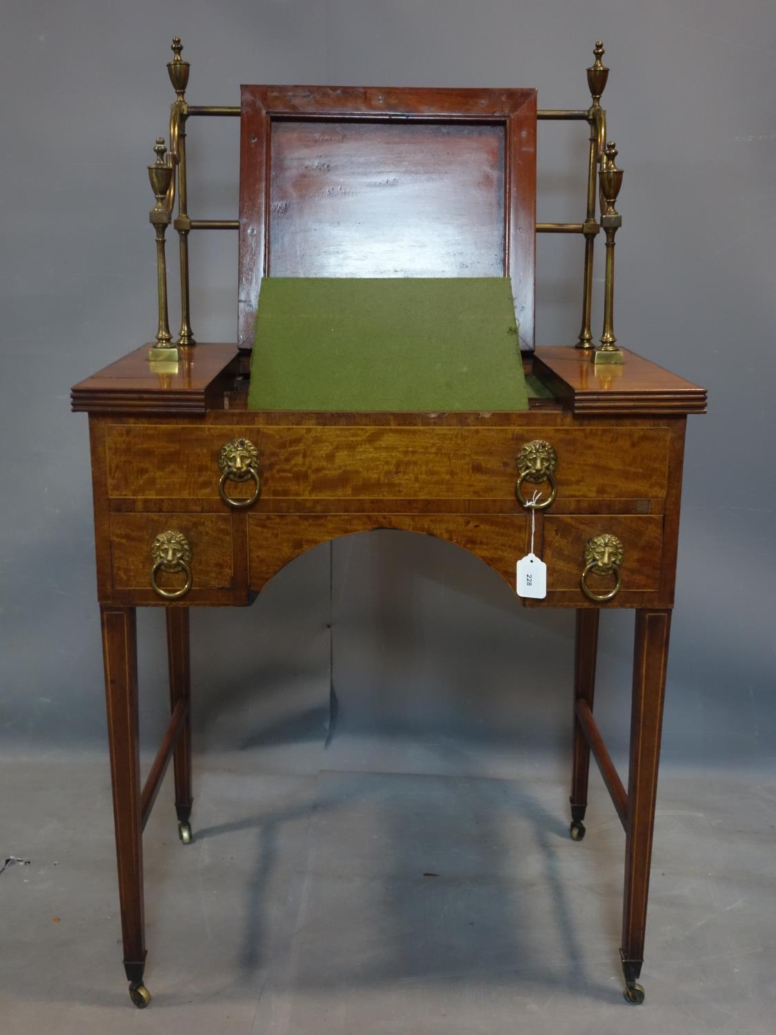 A George III mahogany clerks desk, with brass gallery top, raised on tapered legs and castors, H.130