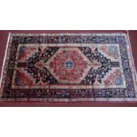 A North west Persian Toserkan rug, the central double pendant medallion with repeating petal motifs,