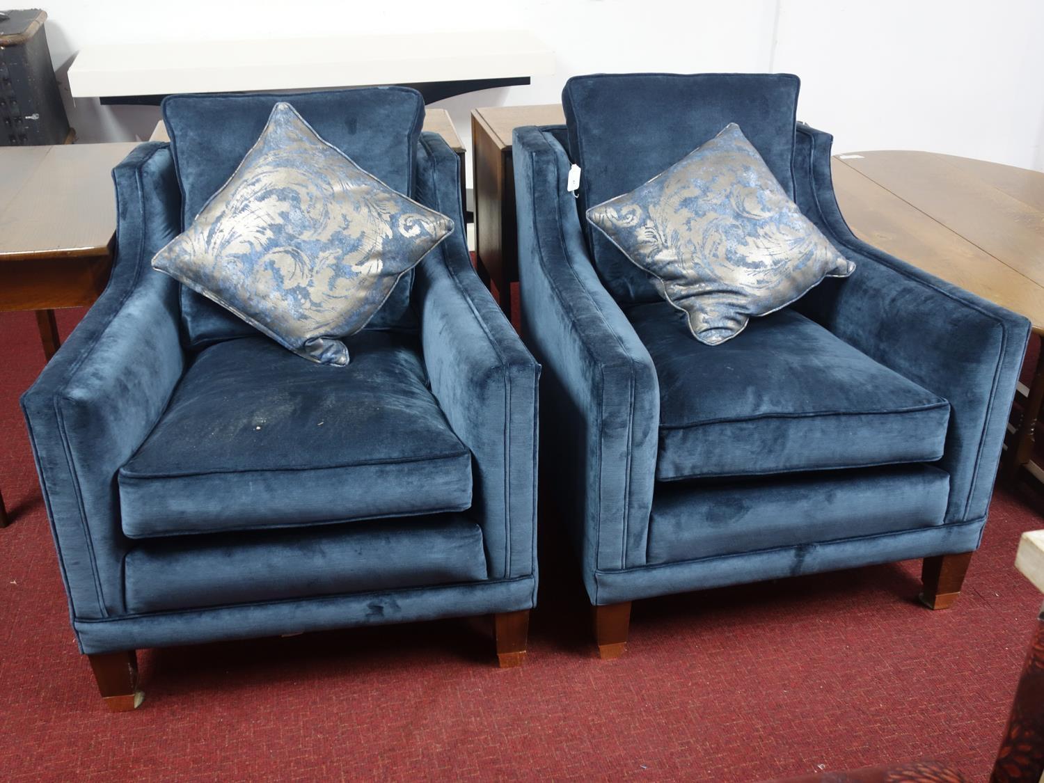 A pair of Duresta 'Trafalgar' armchairs, blue velvet upholstery, raised on tapered legs and brass