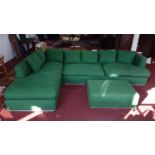 A large green upholstered L shaped sofa, with matching ottoman, 'At Crorin Workshop' label to verso,