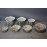 A set of 3 Chinese plant pots and drip trays, together with a set of 4 Chinese bowls