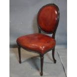 An early 20th century French mahogany balloon back chair, raised on reeded tapered legs