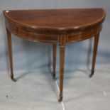 An Edwardian inlaid mahogany card table, raised on tapered legs and castors