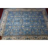 An Afghan vegetable dyed Zeigler carpet, repeating floral motifs on a blue ground within cream