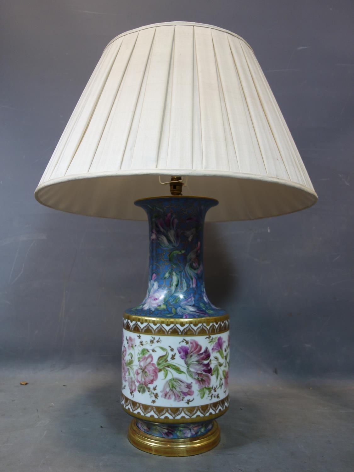 A large 20th century porcelain lamp, hand painted with flowers and gilt, possibly by Limoges, with
